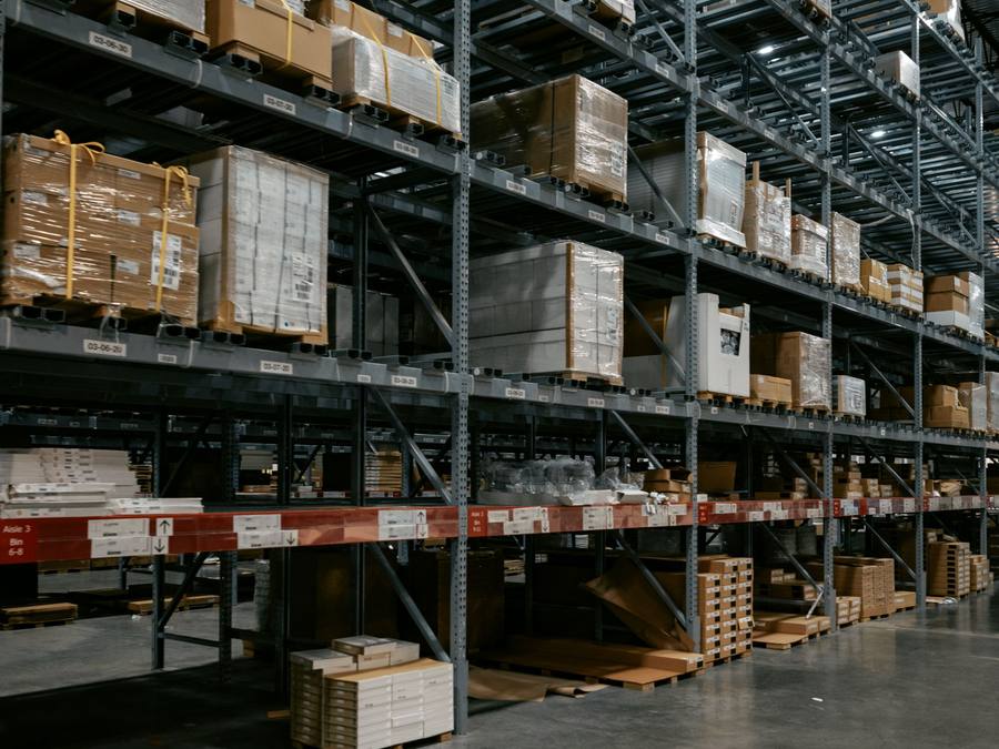 Secure Calgary warehouse storage aisle with padded, inventoried furniture handled by Western Provincial Movers